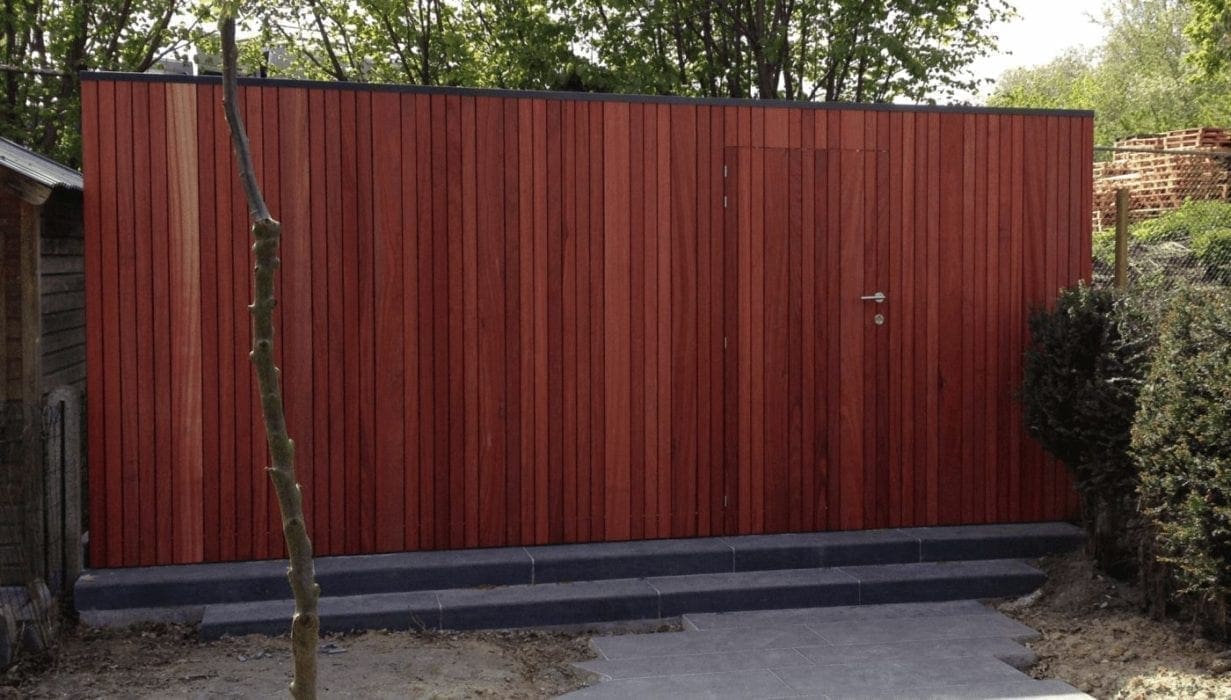 Houten omheining met geïntegreerde deur langs tuinpad